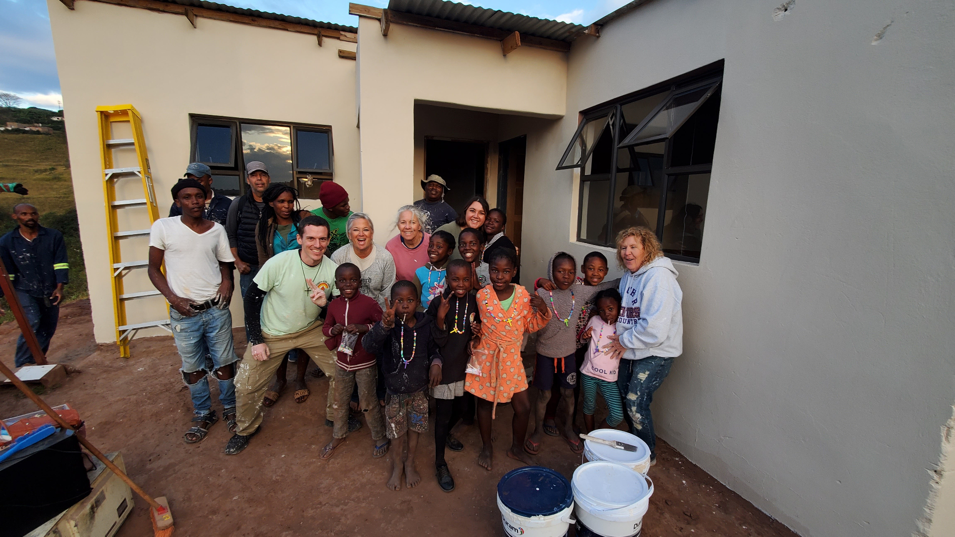 Ntombikayise's family and the team gathered in front of the finished home
