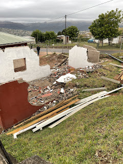 A neighboring family's home, half of it lost in the flood