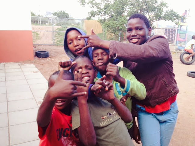 A group of Ntshongweni youth posing together outside