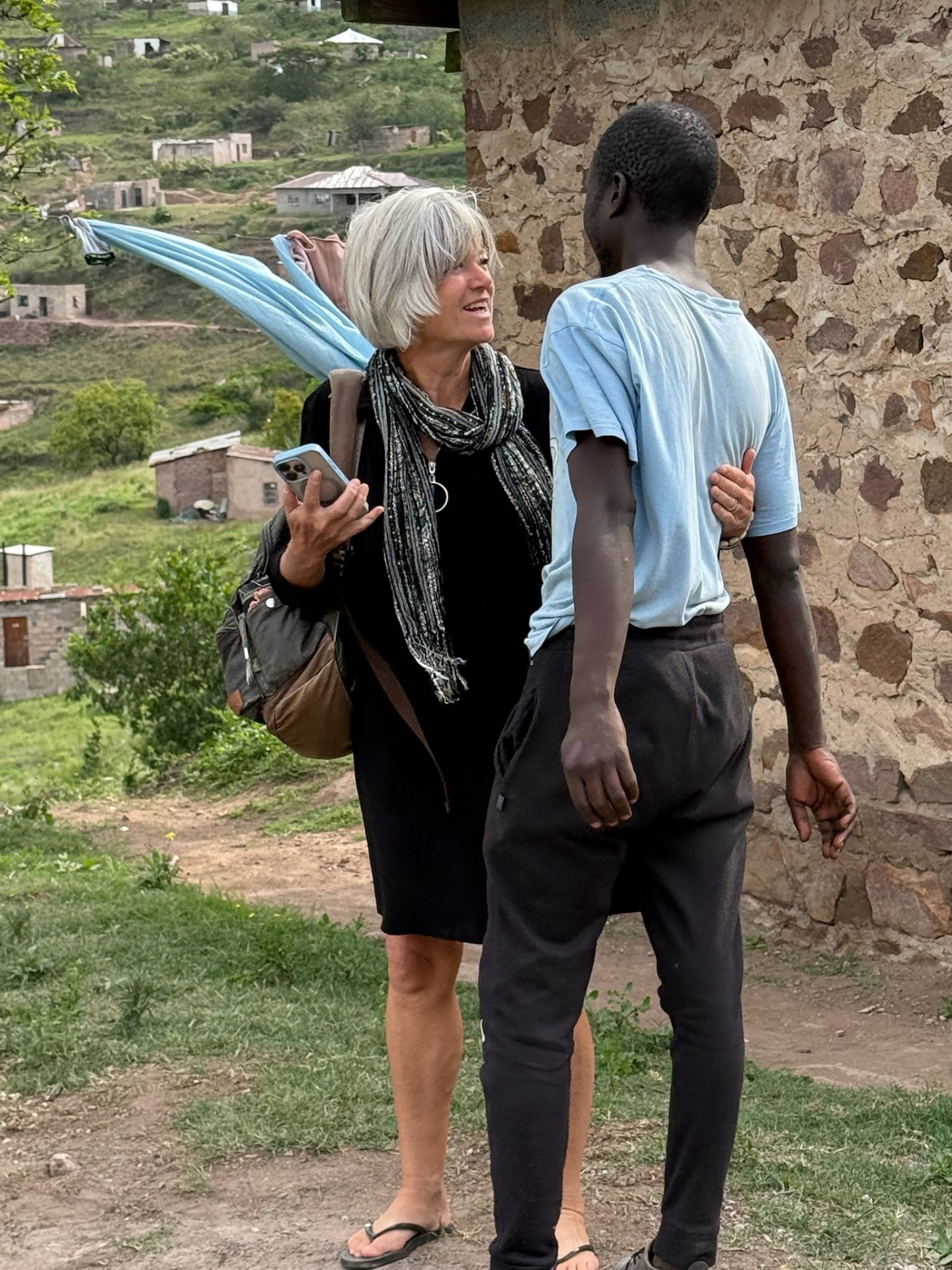 A visiting friend talking with one of the Duma brothers outside the family&rsquo;s stone home