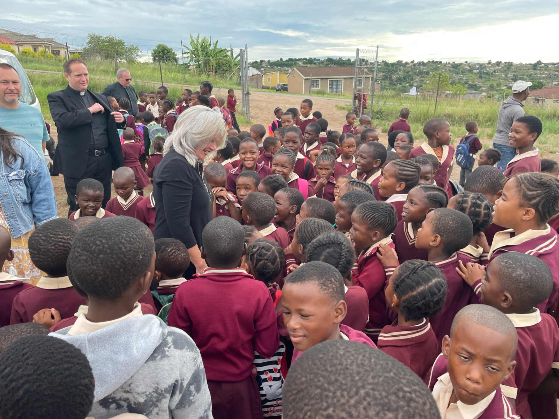 A friend surrounded by Ntshongweni primary students