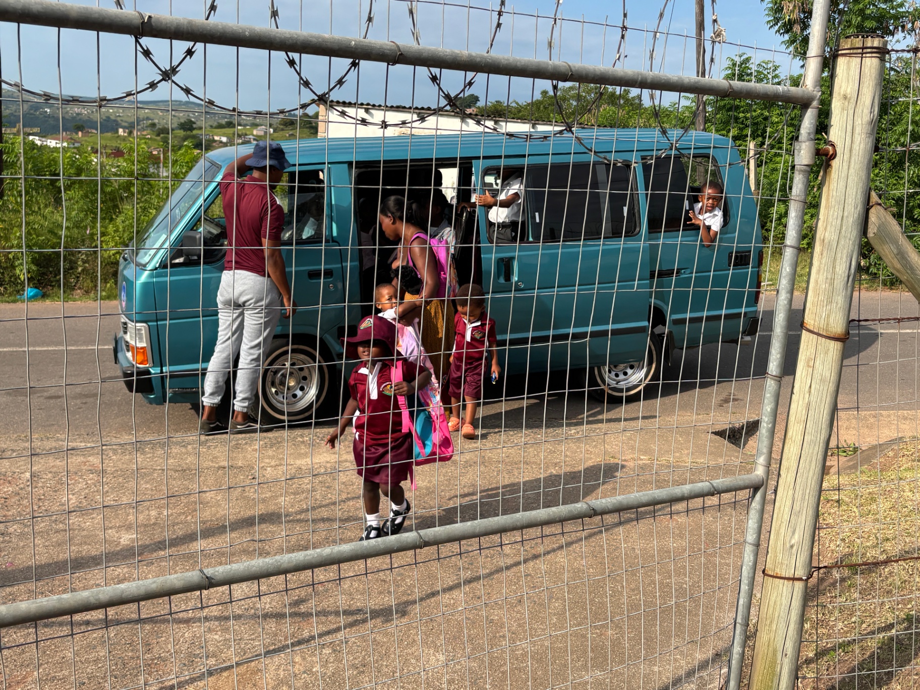Preschoolers arriving at the creche gate from a minibus taxi in the morning