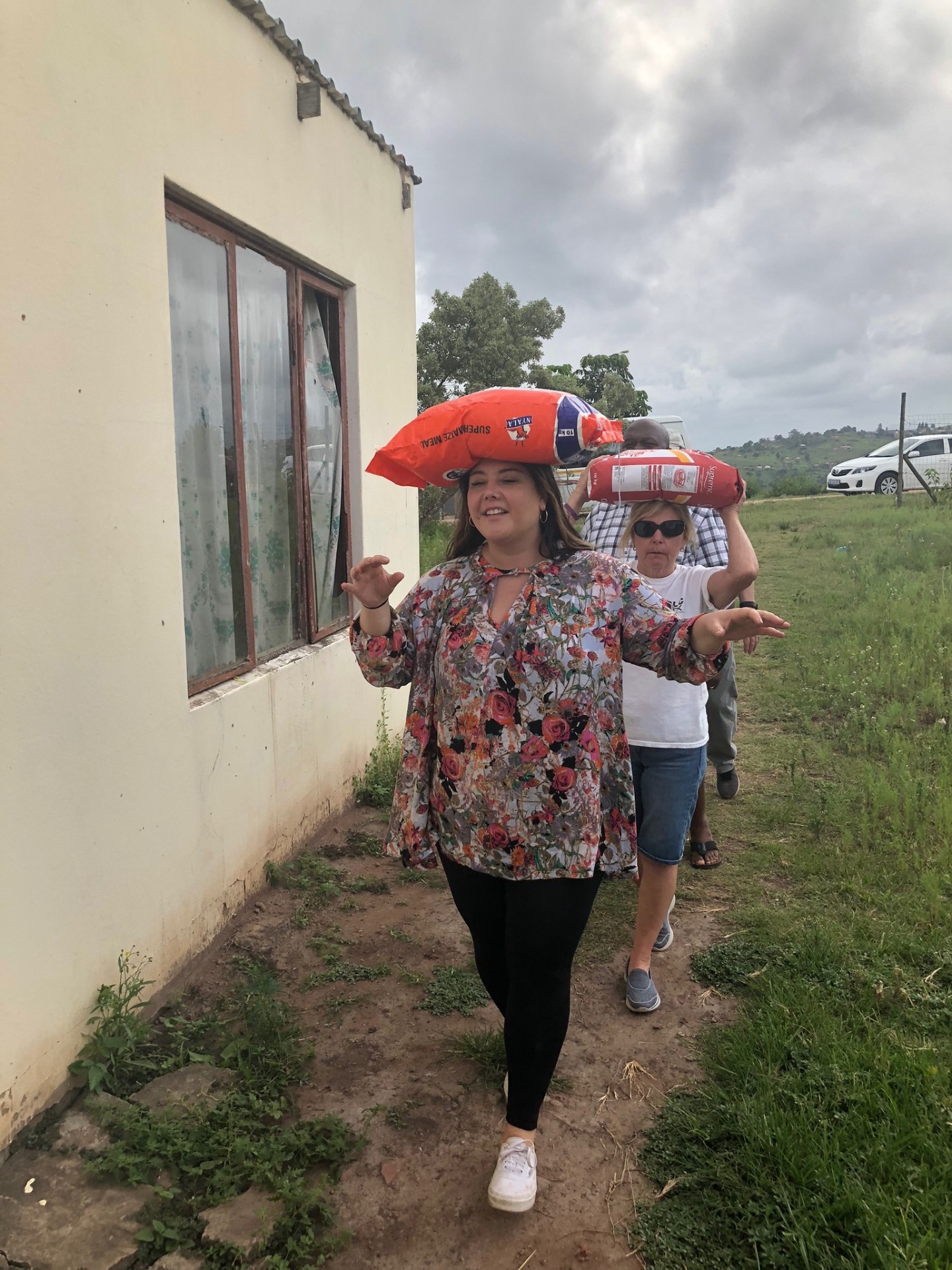 A friend of the mission carrying a bag of maize meal on her head