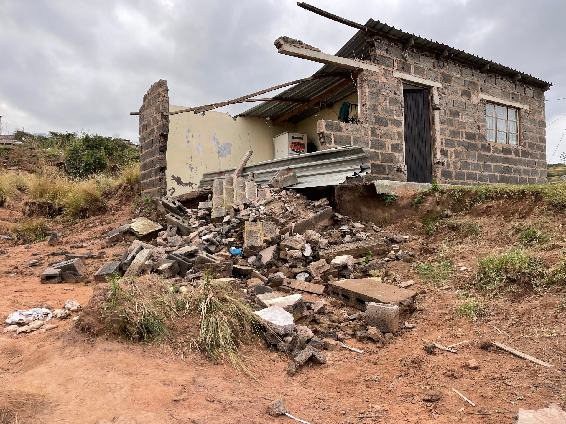 Zanele's collapsed home after the flood, only the porch and rondeval remaining