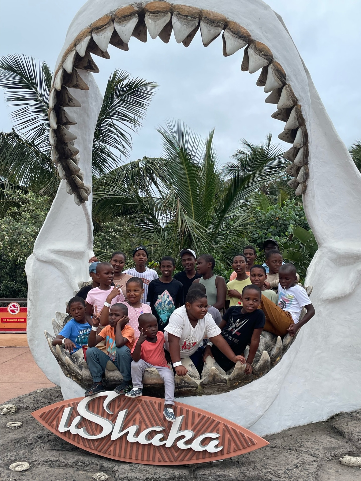 Children and teens gathered during an outing to uShaka