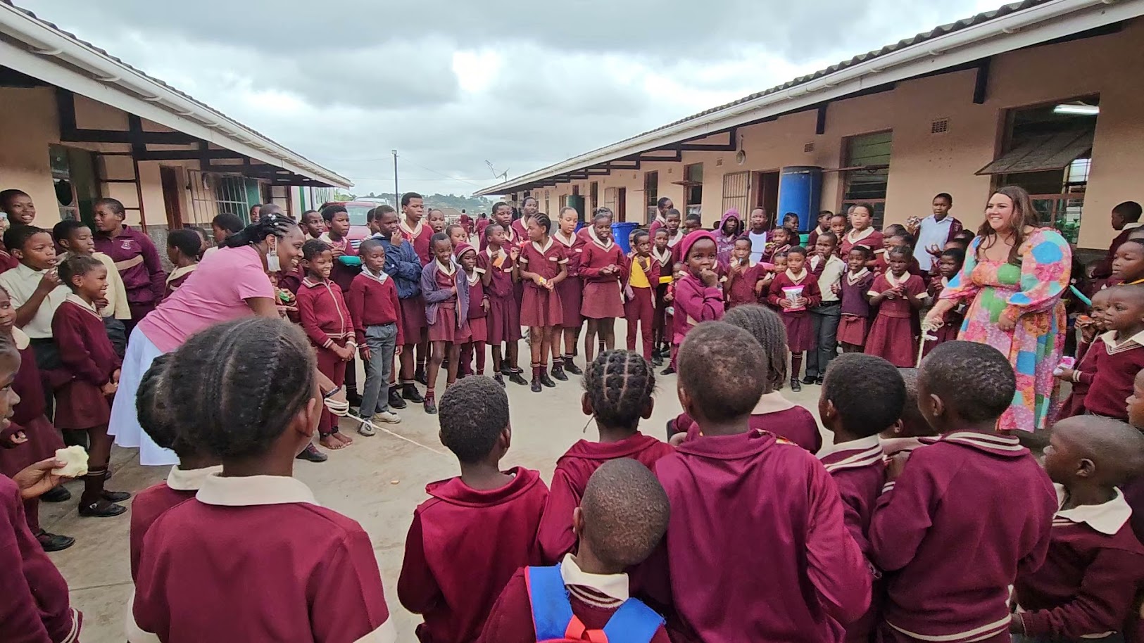Students in a wide circle in the schoolyard