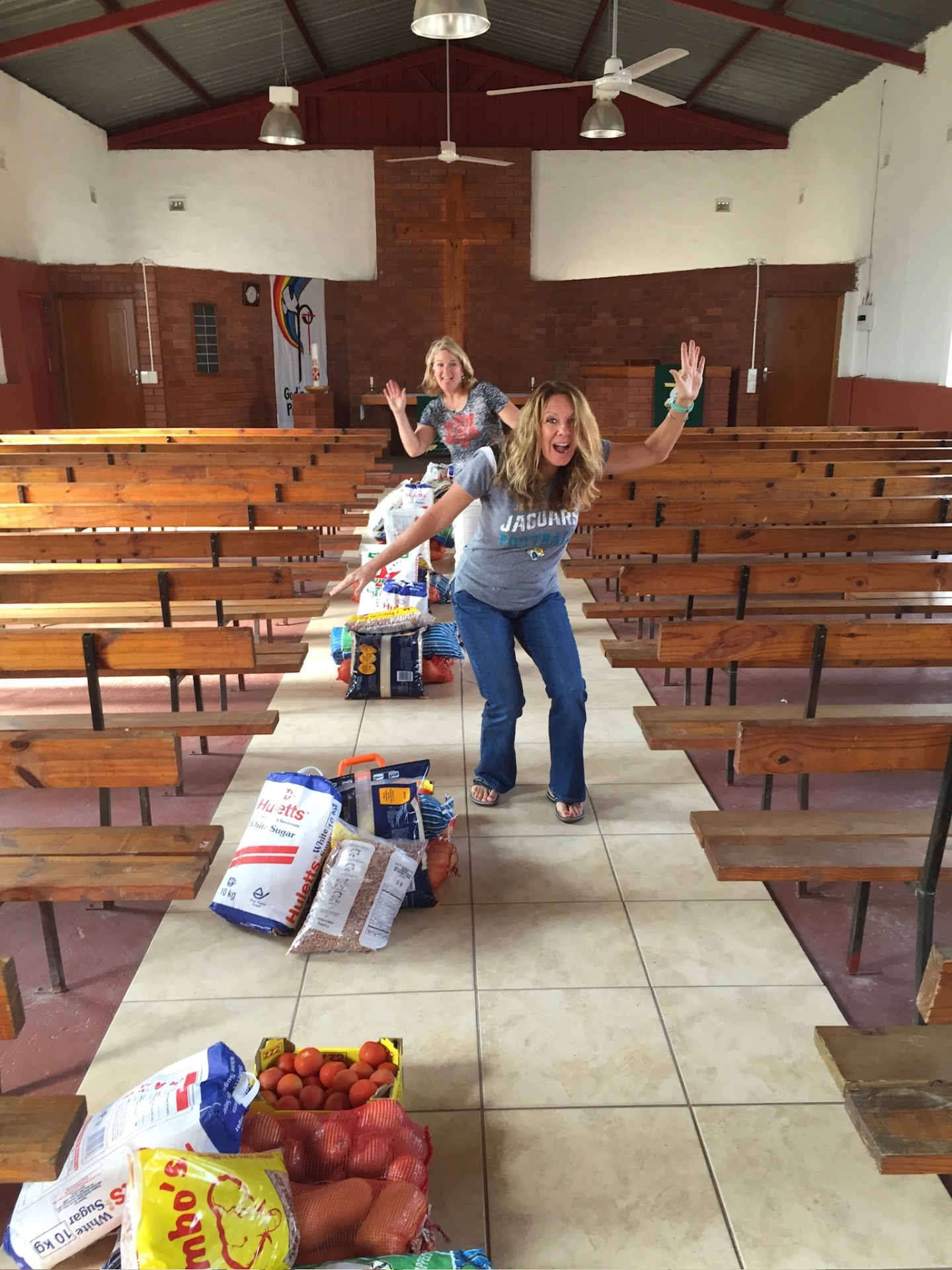 Food parcels lined up down the center aisle of the church as friends prepare for delivery day