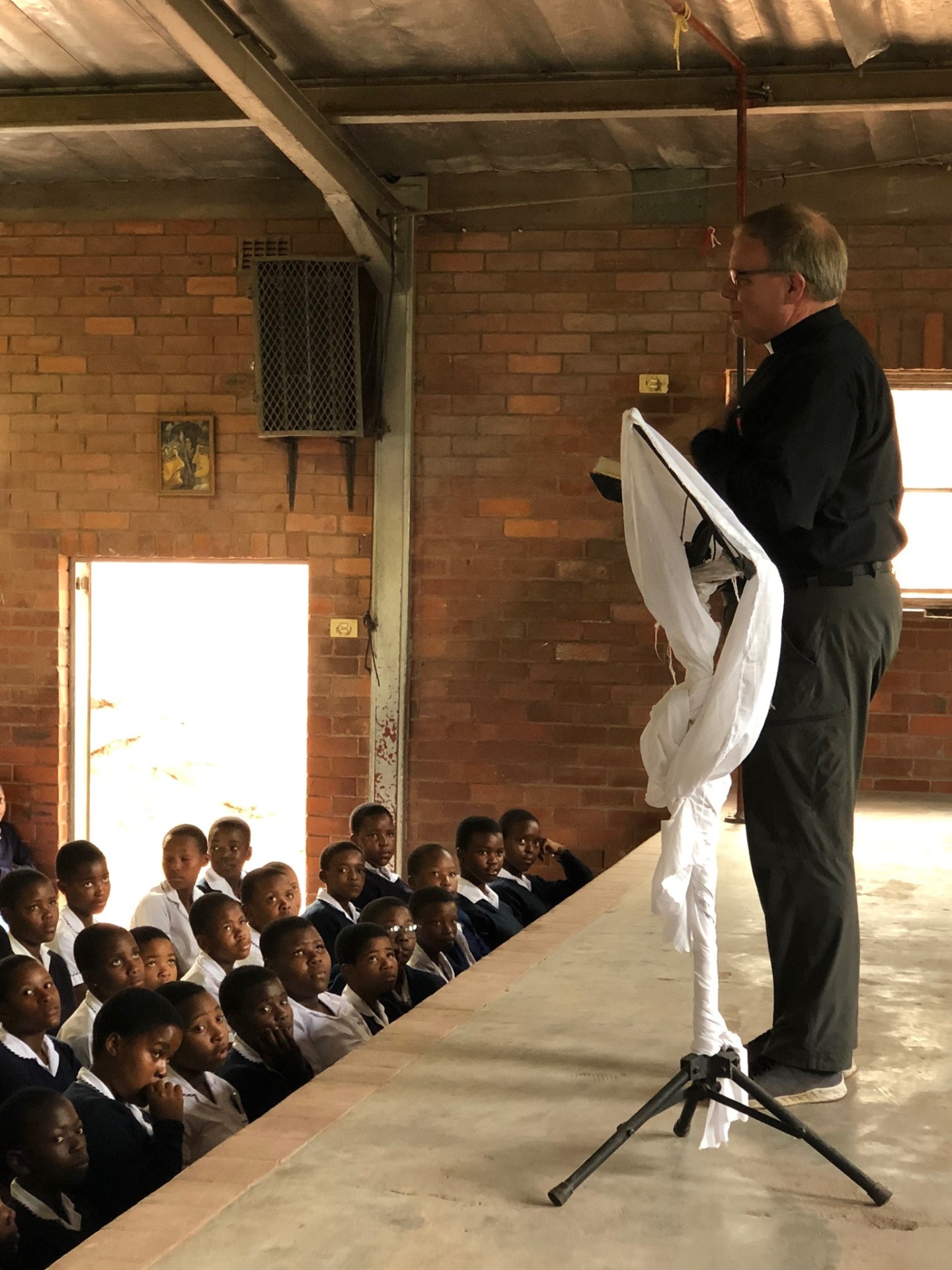 A pastor speaking from Scripture to high school students