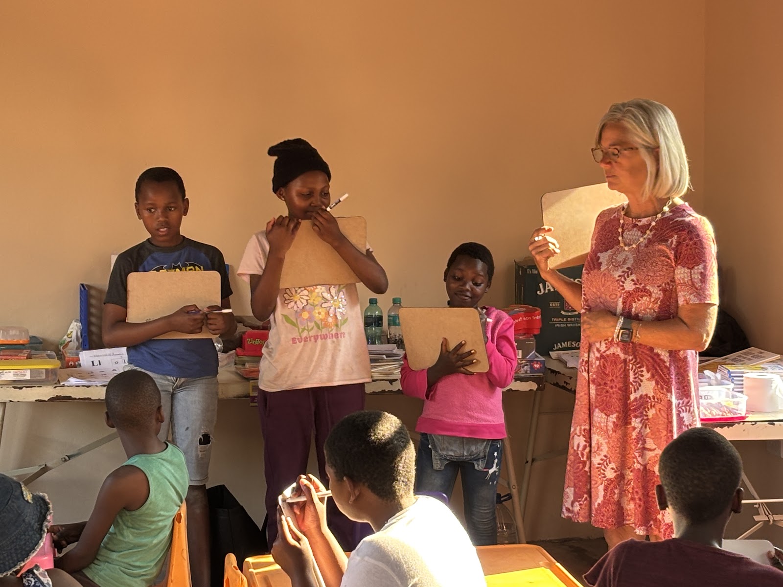 Children reading the same English book together during tutoring
